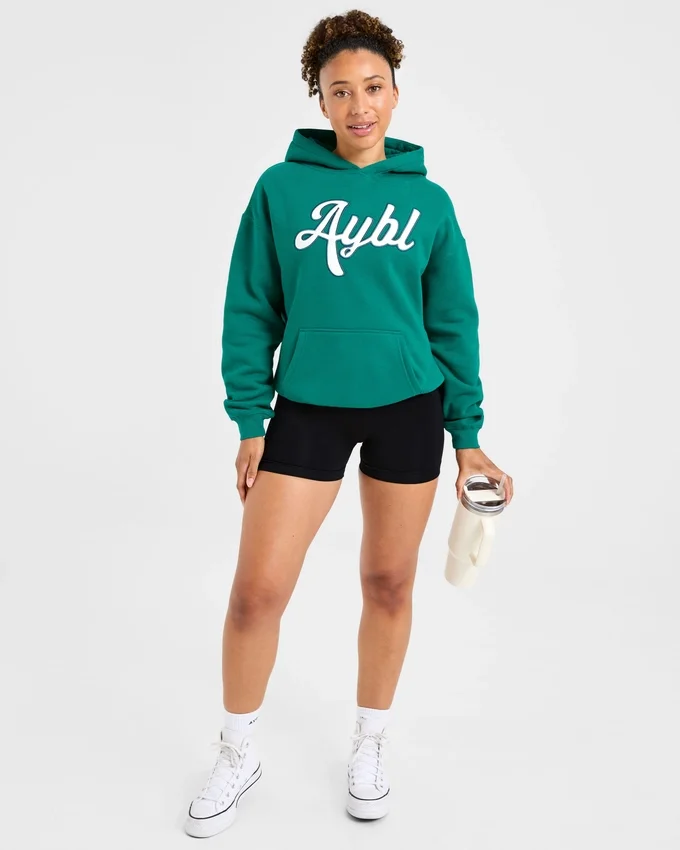 Oversized-hoodie med broderad text