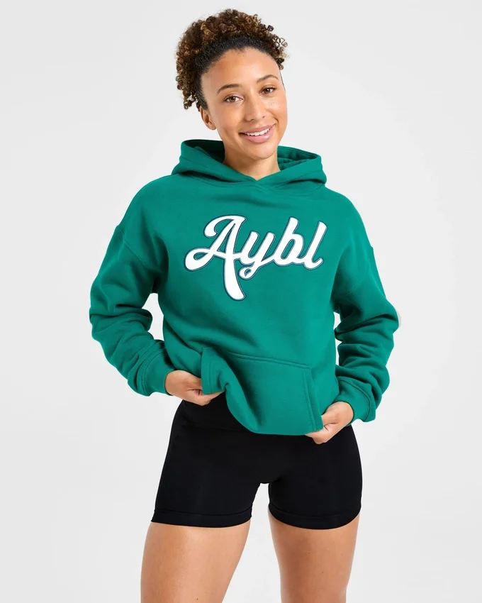 Oversized-hoodie med broderad text